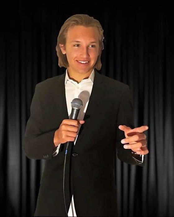 DJ Duke holding a microphone.