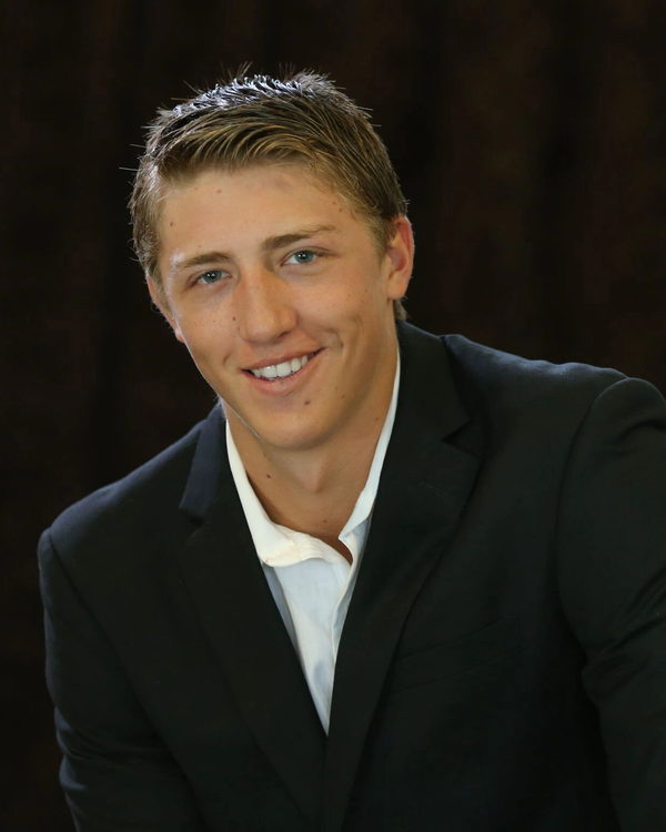 DJ Heston, photographed in a dark suit.